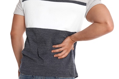 Man suffering from backache on white background, closeup