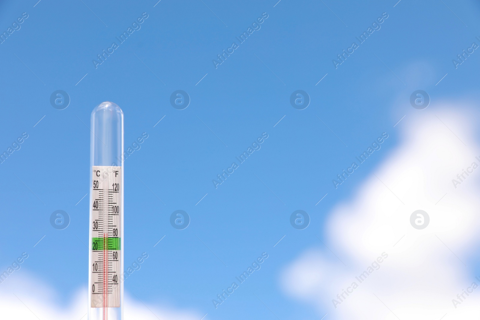 Photo of Weather thermometer against blue sky, space for text