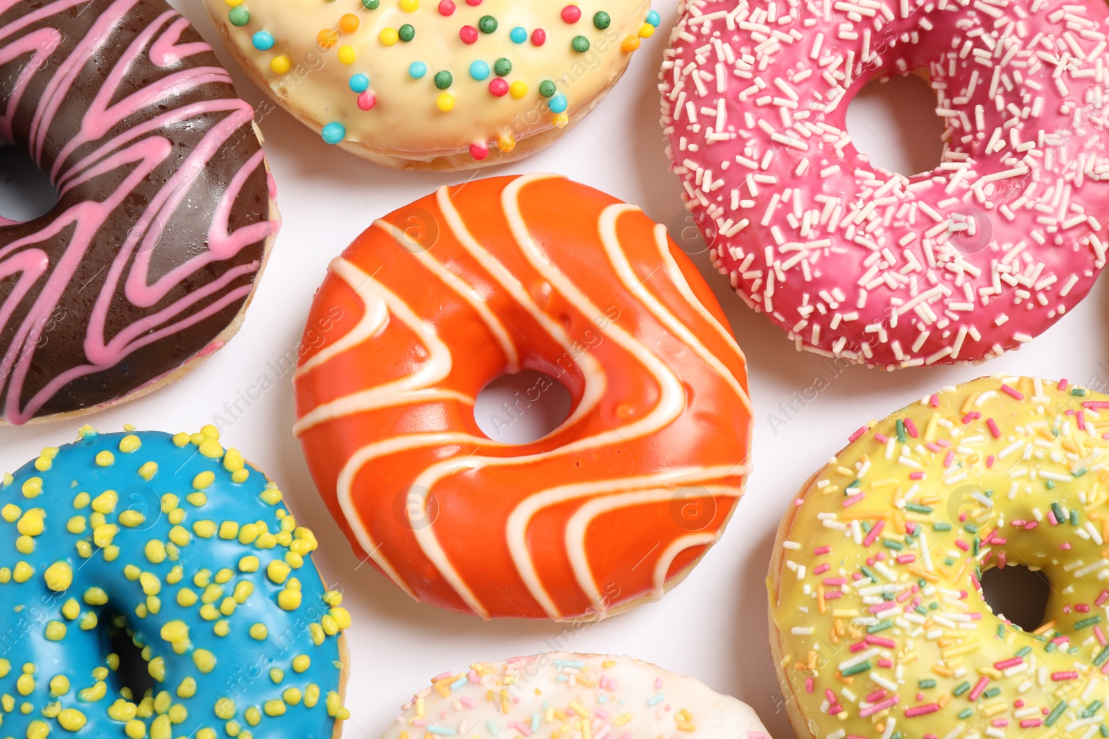 Photo of Delicious glazed donuts on white background, flat lay