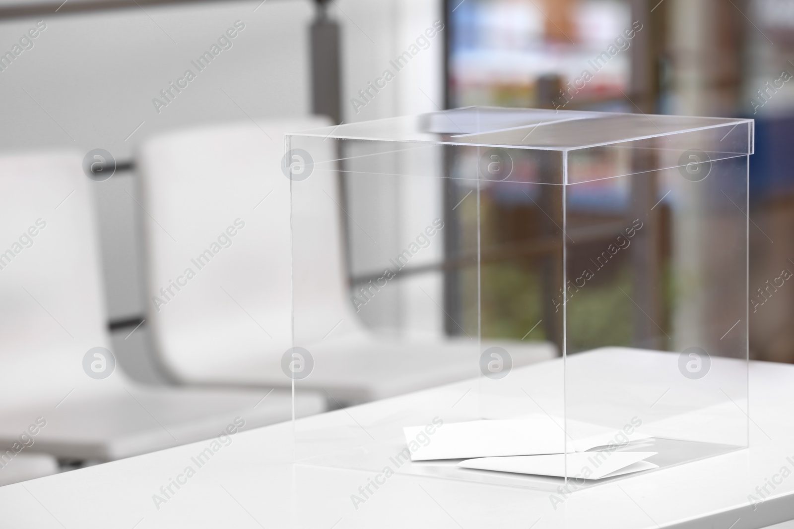 Photo of Ballot box on table at polling station. Space for text