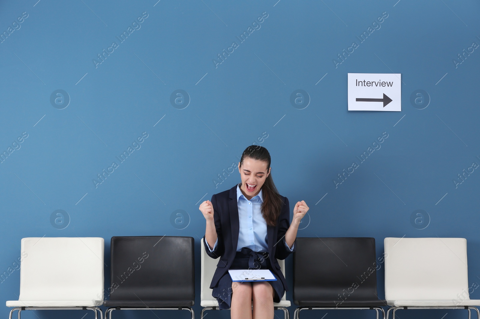 Photo of Young woman being happy after success job interview, indoors