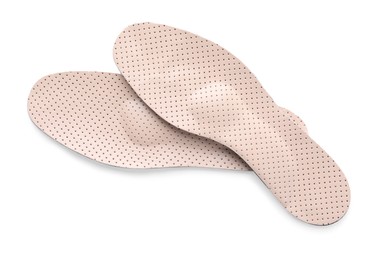 Beige orthopedic insoles isolated on white, top view