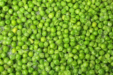 Photo of Frozen peas as background, top view. Vegetable preservation