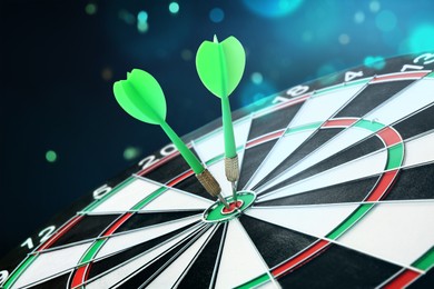 Image of Dart board with green arrows hitting target against dark background, bokeh effect