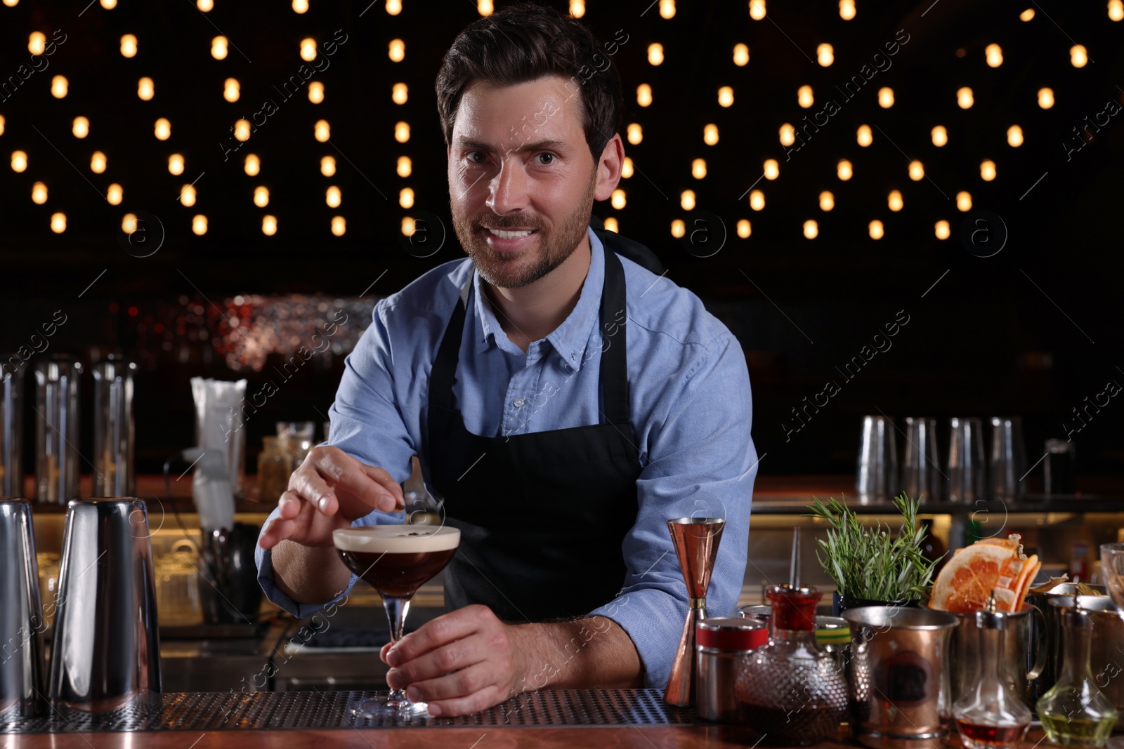 Photo of Bartender preparing Espresso Martini in bar. Alcohol cocktail