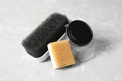 Photo of Shoe care accessories on light grey background