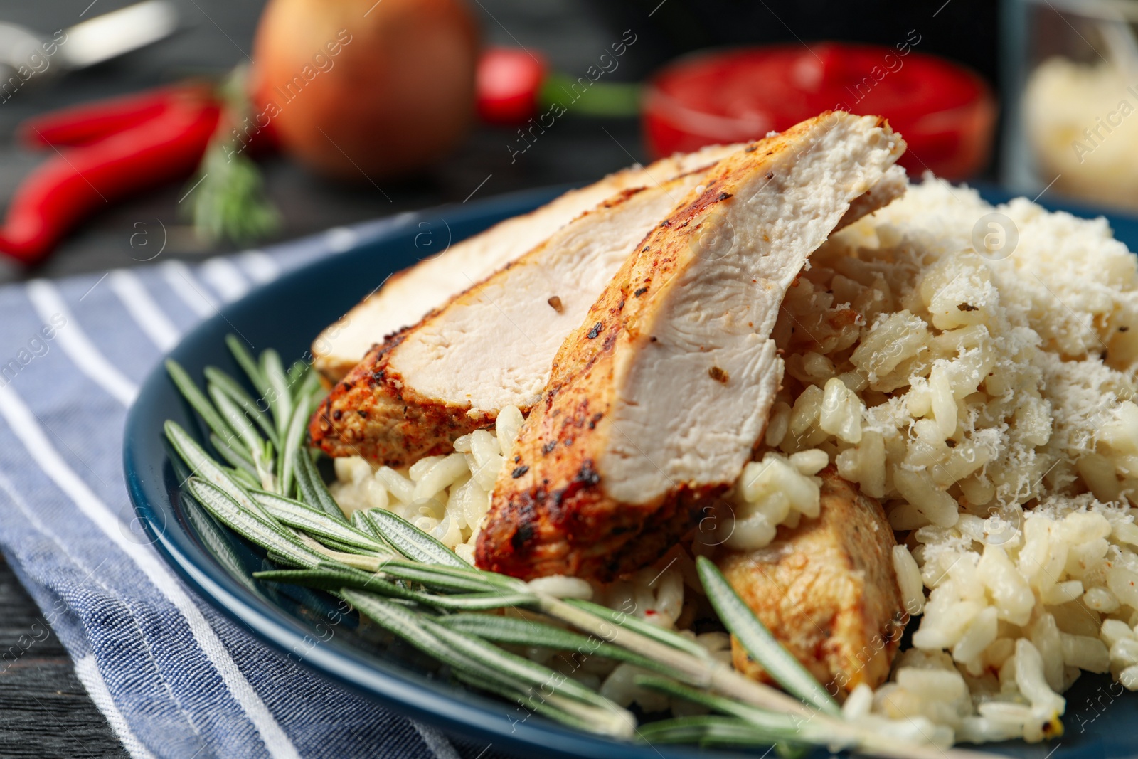 Photo of Delicious risotto with chicken on plate, closeup