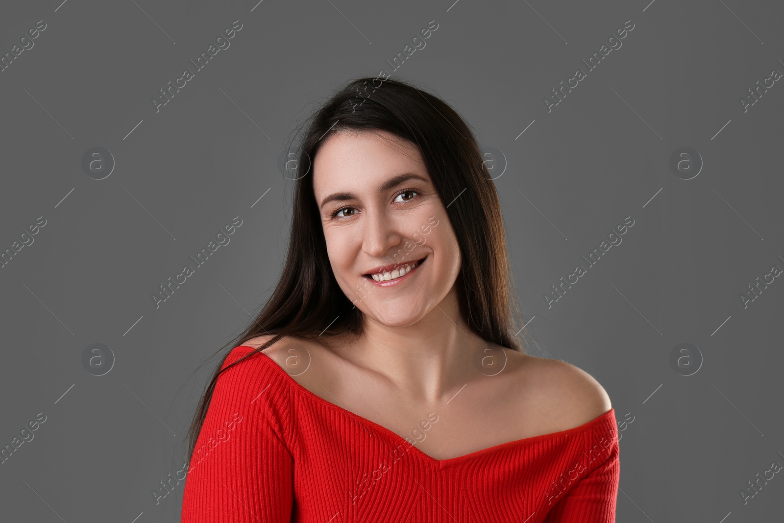 Photo of Portrait of beautiful young woman on grey background