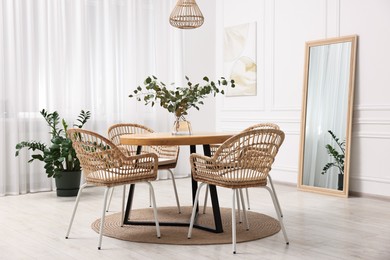 Dining room interior with comfortable furniture and plants