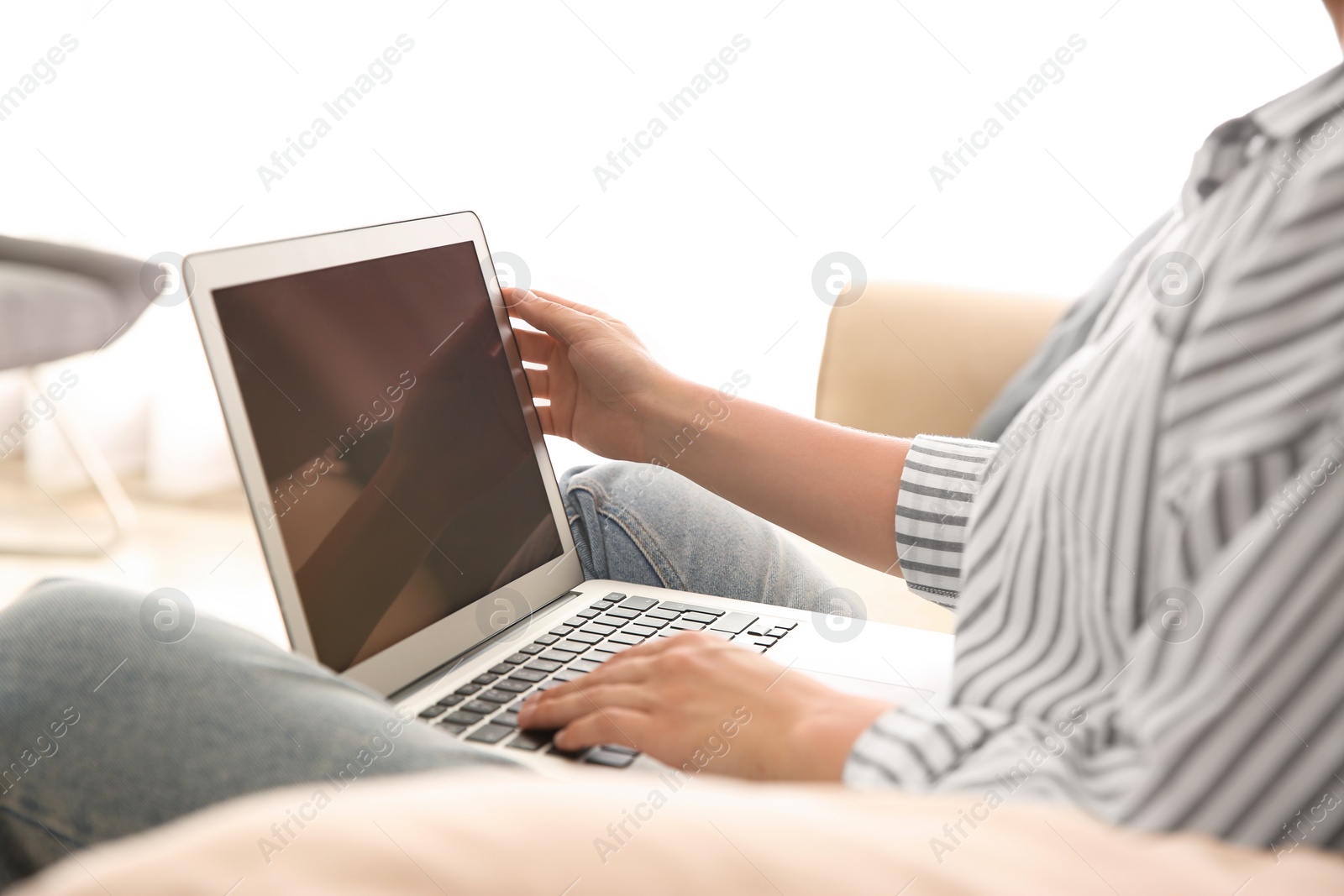 Photo of Woman working with modern laptop indoors, closeup