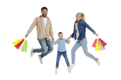 Family shopping. Happy parents and daughter jumping with many colorful bags on white background