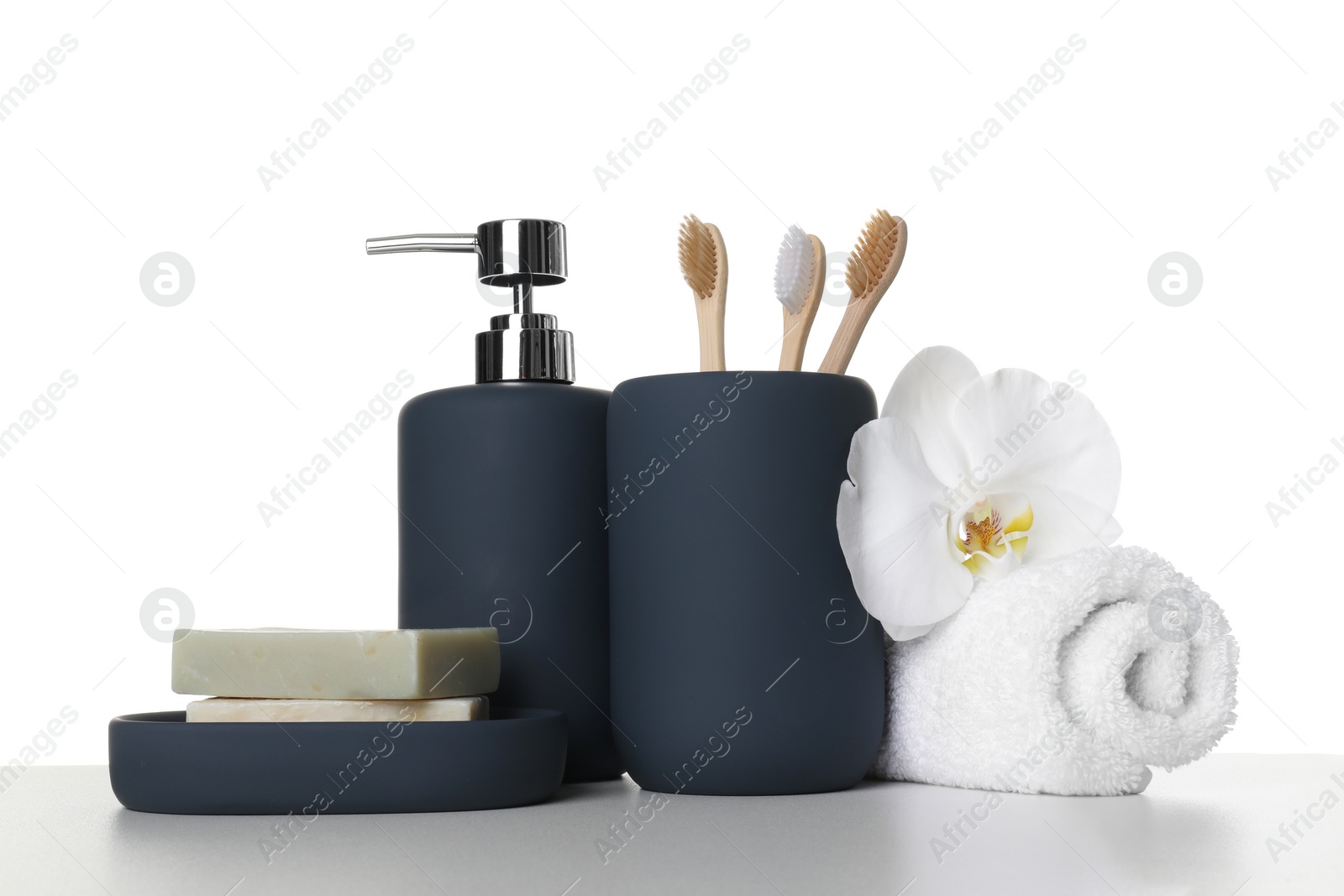 Photo of Bath accessories. Different personal care products and flower on table against white background