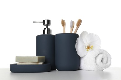 Bath accessories. Different personal care products and flower on table against white background