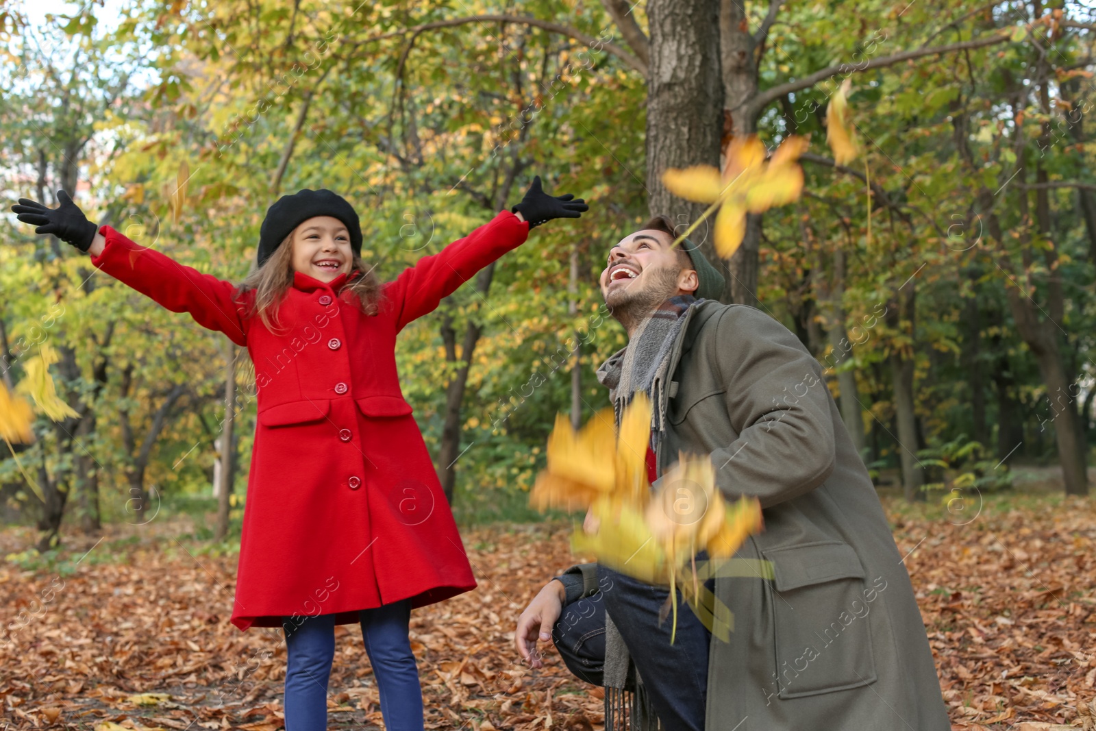 Photo of Father and his cute daughter spending time together in park. Autumn walk