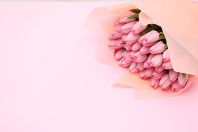Photo of Bouquet of beautiful tulips on pink background, closeup. Space for text