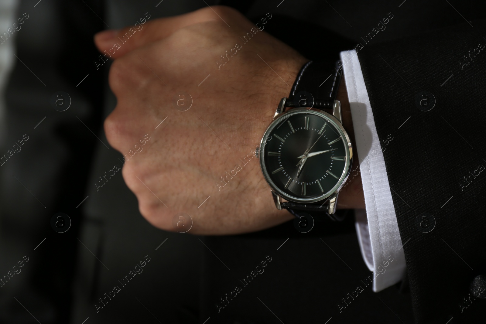 Photo of Businessman in suit with luxury wrist watch, closeup