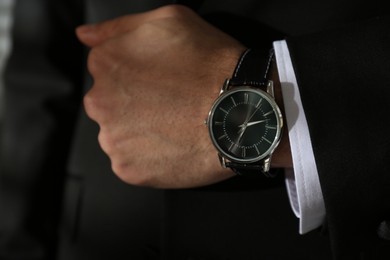 Photo of Businessman in suit with luxury wrist watch, closeup