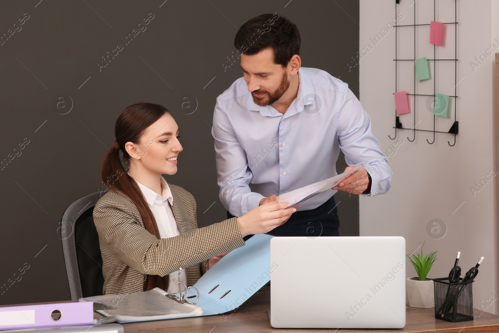 Photo of Businesspeople working together with documents in office