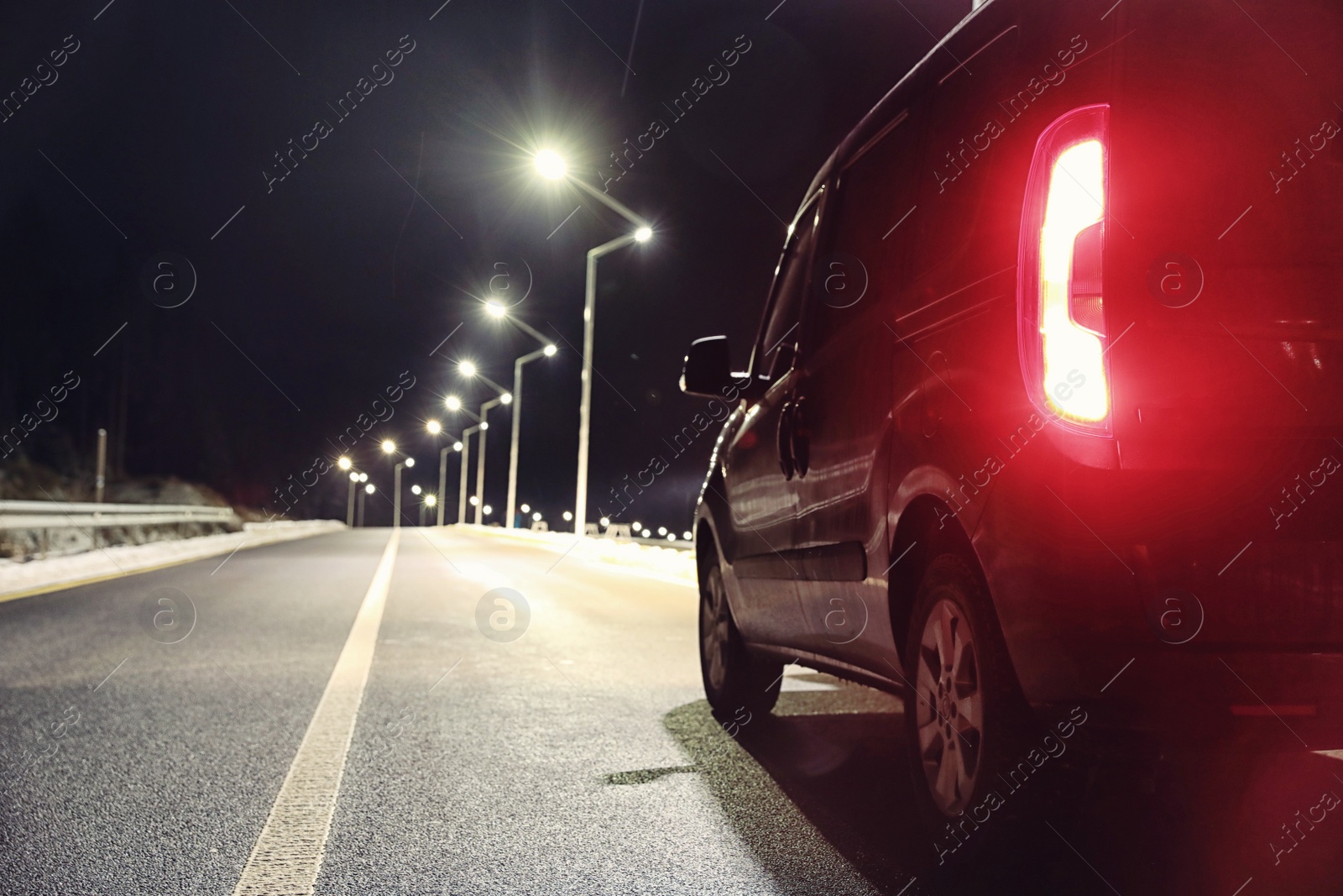 Photo of Modern car on asphalt road at night