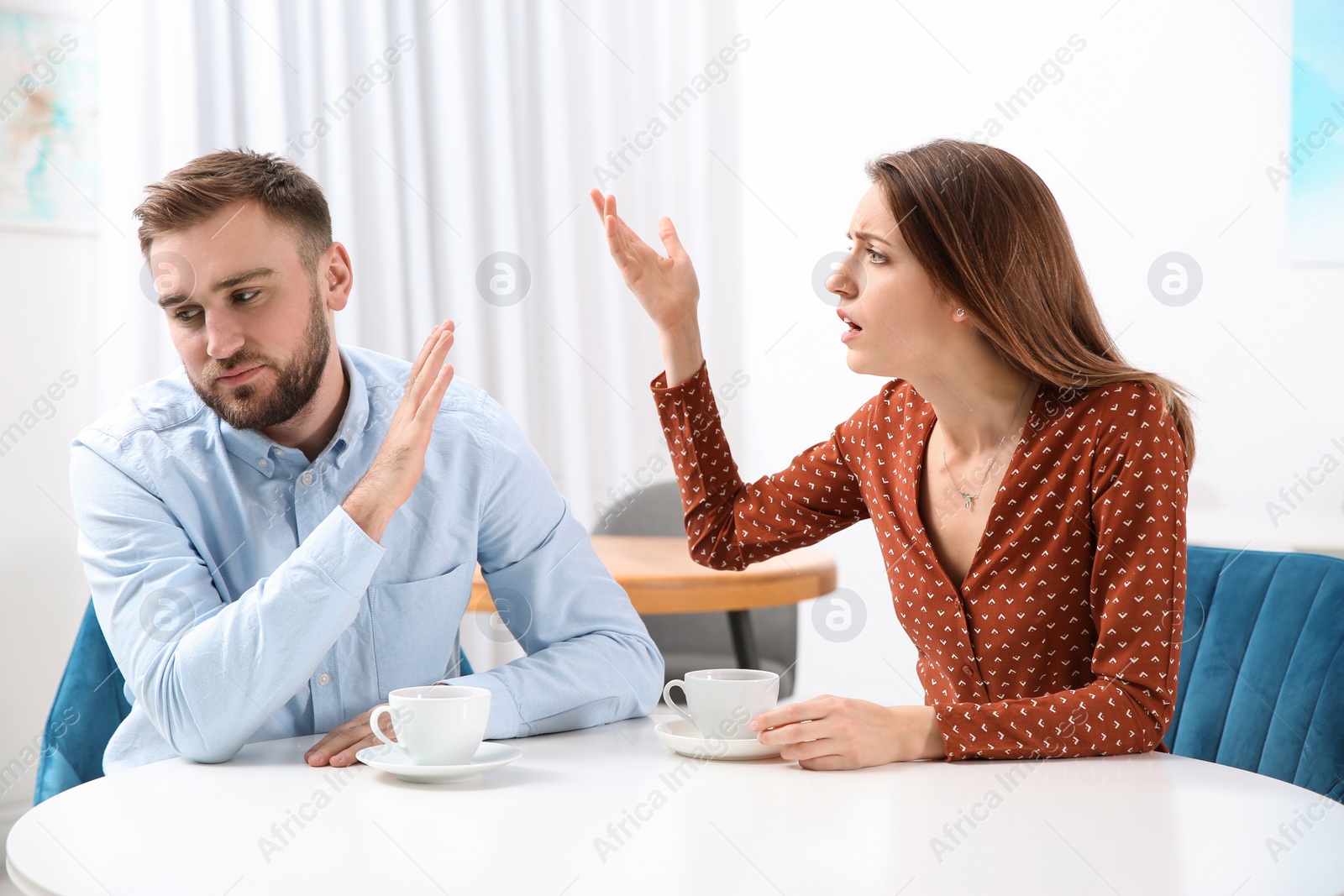 Photo of Couple having quarrel in cafe. Relationship problems