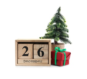 Wooden block calendar with Boxing Day date, gift and decorative Christmas tree on white background