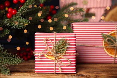 Photo of Beautifully wrapped gift boxes on wooden table