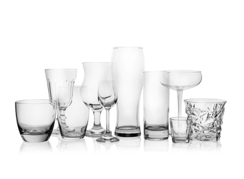 Photo of Set of empty glasses for different drinks on white background