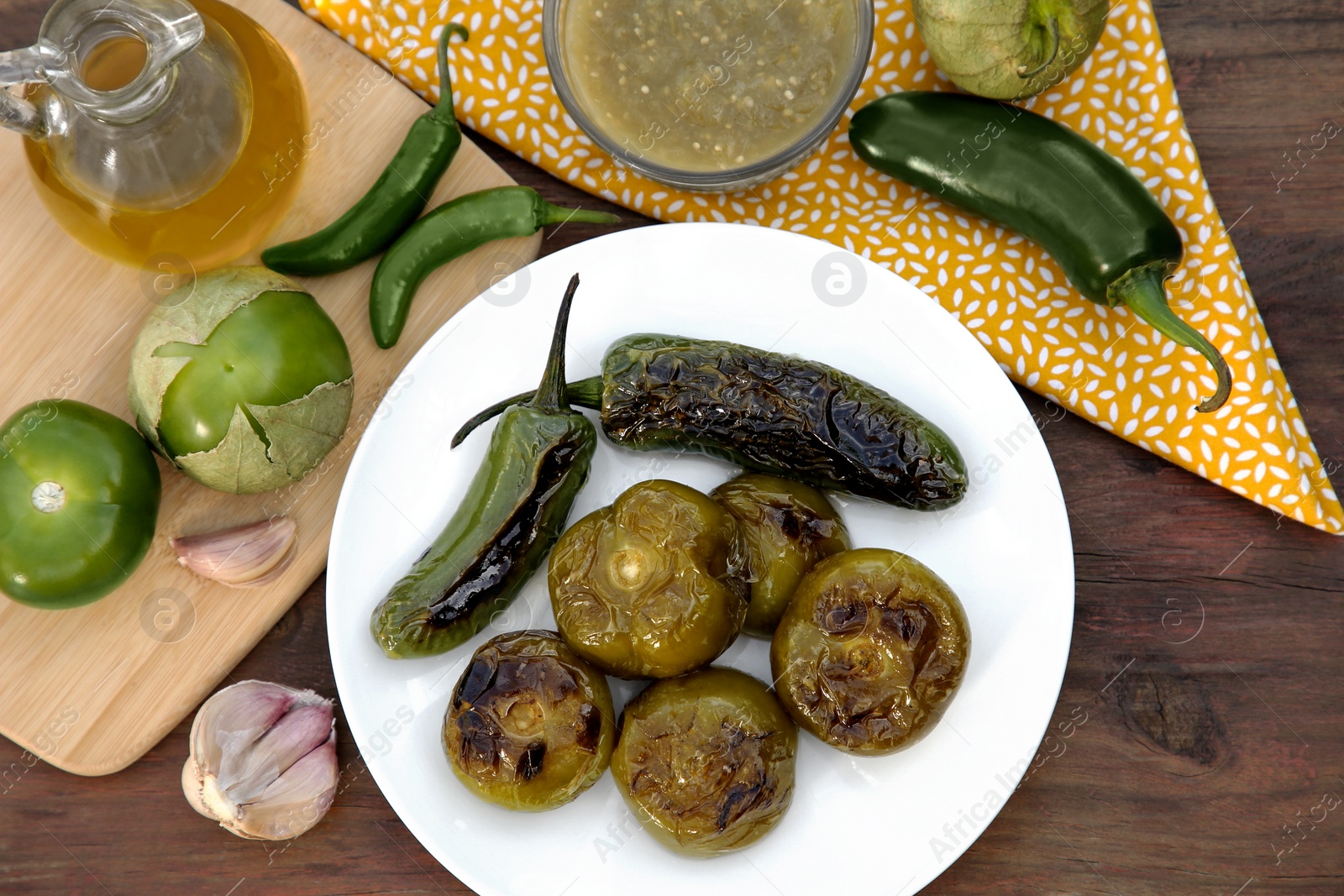 Photo of Different ingredients and tasty salsa sauce on wooden table, flat lay