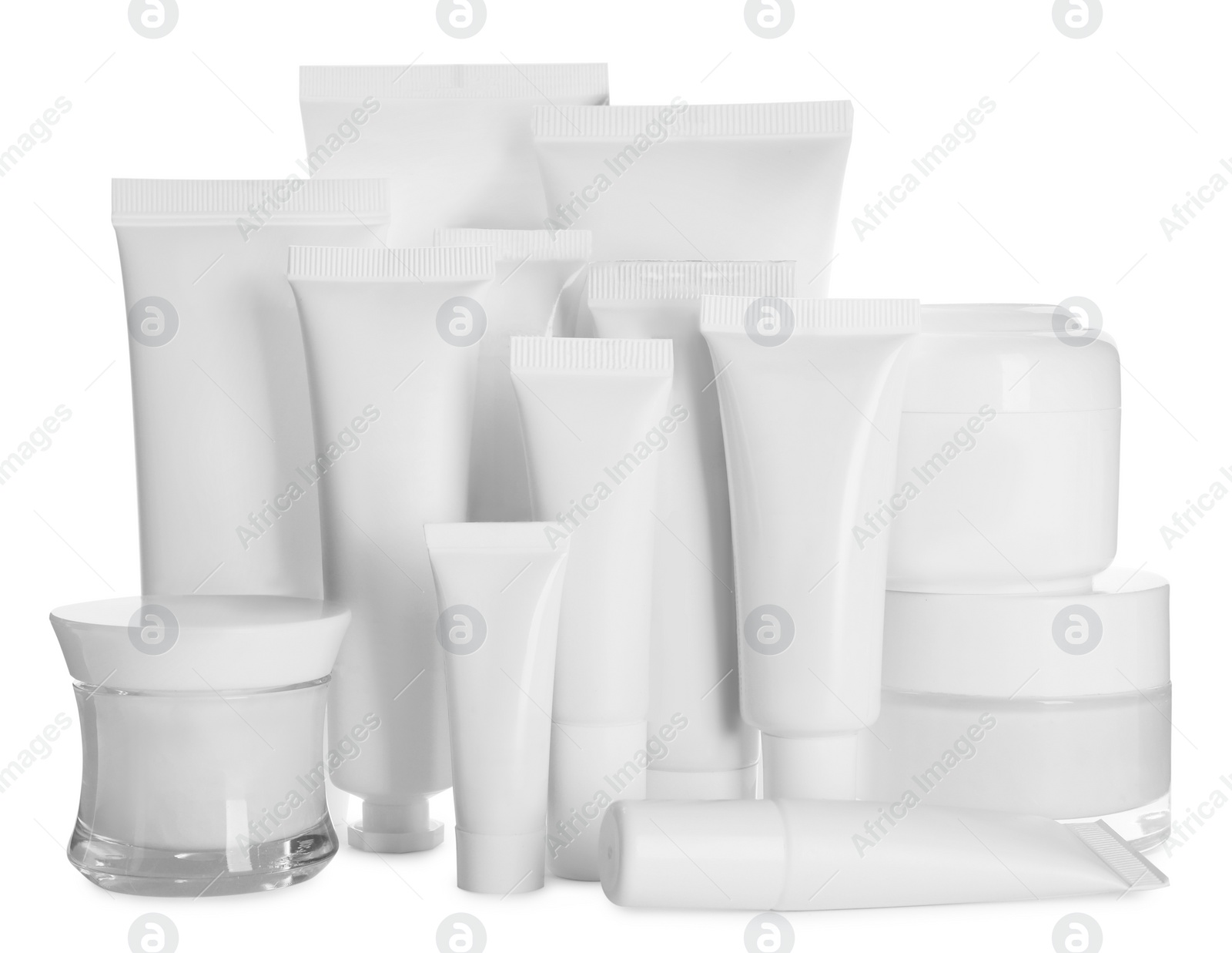 Photo of Blank tubes and jars of cosmetic products on white background