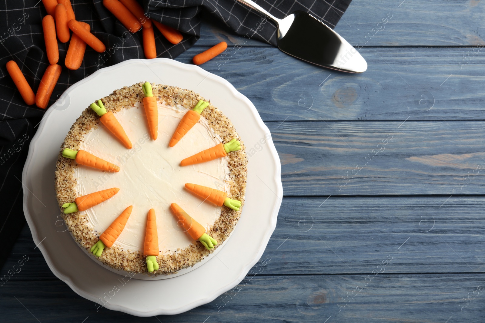 Photo of Flat lay composition with delicious carrot cake on blue wooden background, space for text