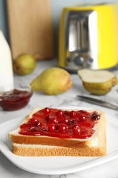 Slice of bread with jam on plate