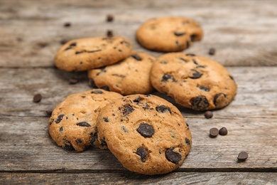 Photo of Delicious chocolate chip cookies on wooden table