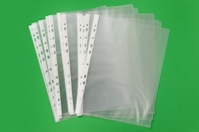 Photo of Punched pockets on green background, flat lay