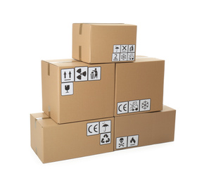 Photo of Stack of cardboard boxes with different packaging symbols on white background. Parcel delivery