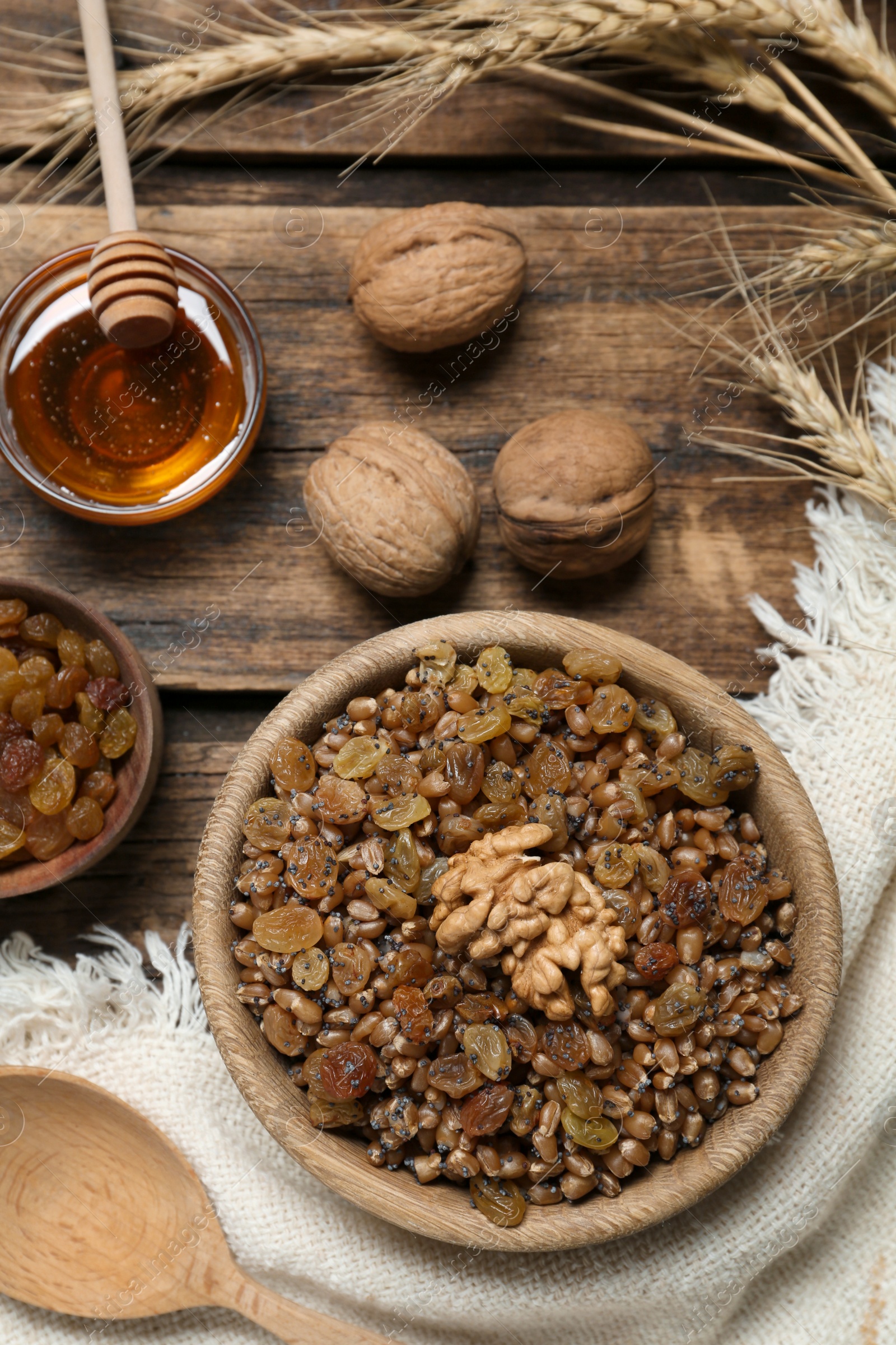 Photo of Traditional Christmas slavic dish kutia served on wooden table, flat lay