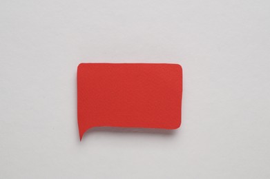 Red paper speech bubble on white background, top view. Space for text