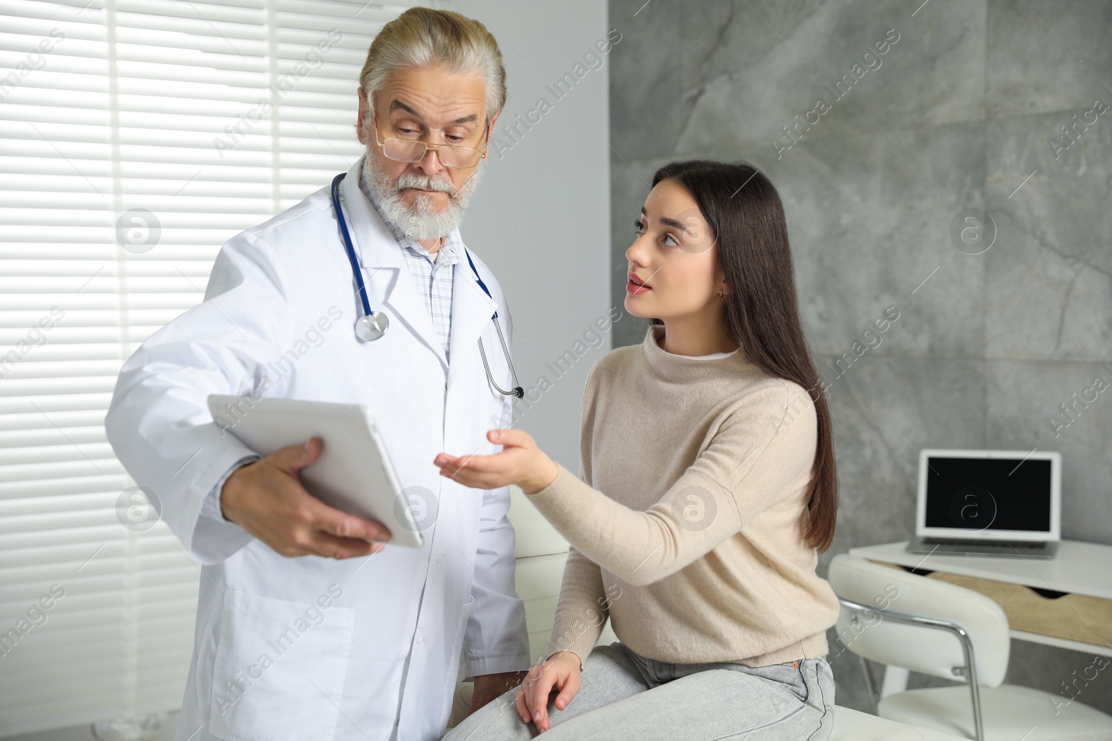 Photo of Patient having appointment with senior doctor in clinic