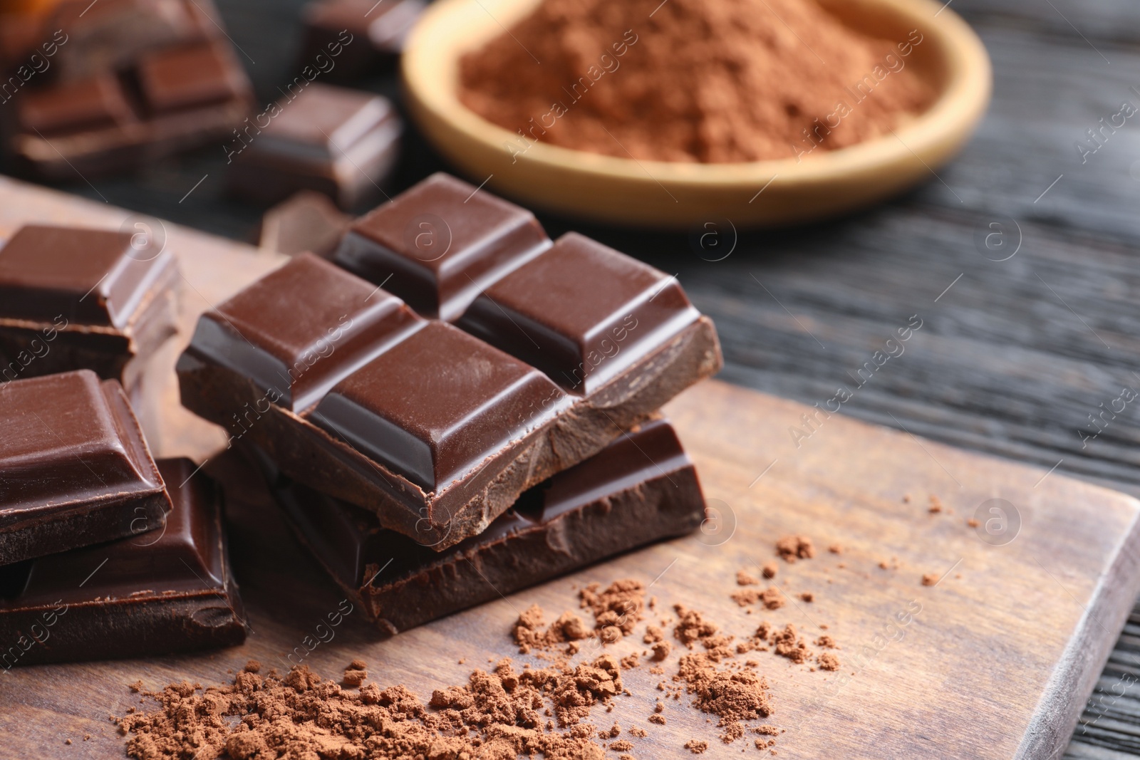 Photo of Pieces of black chocolate on wooden board