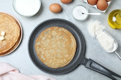 Photo of Flat lay composition with thin pancakes on grey marble table
