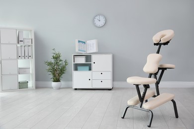 Photo of Modern massage chair in clinic, space for text. Medical equipment