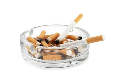 Photo of Glass ashtray with cigarette stubs isolated on white