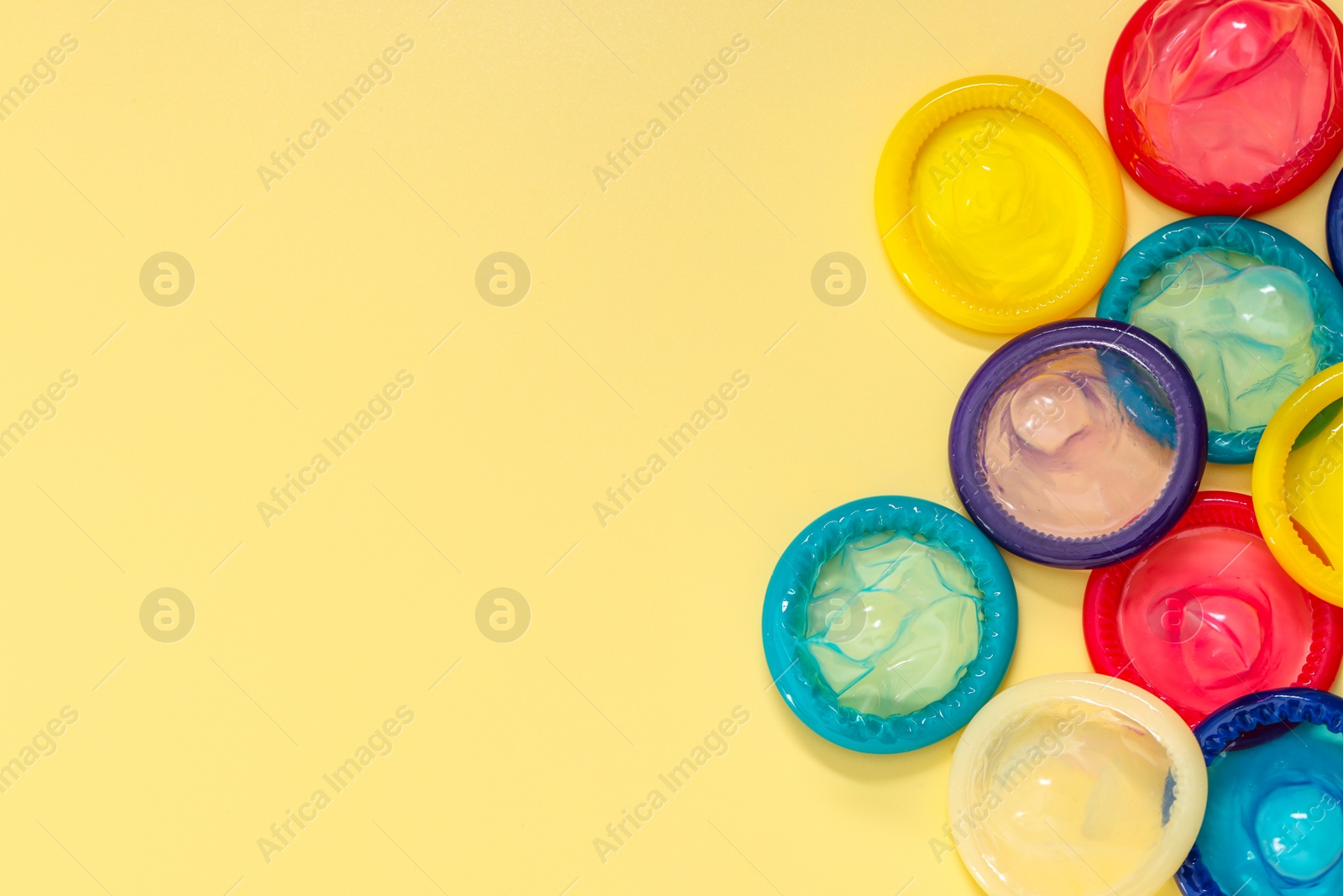 Photo of Condoms on beige background, top view with space for text. Safe sex
