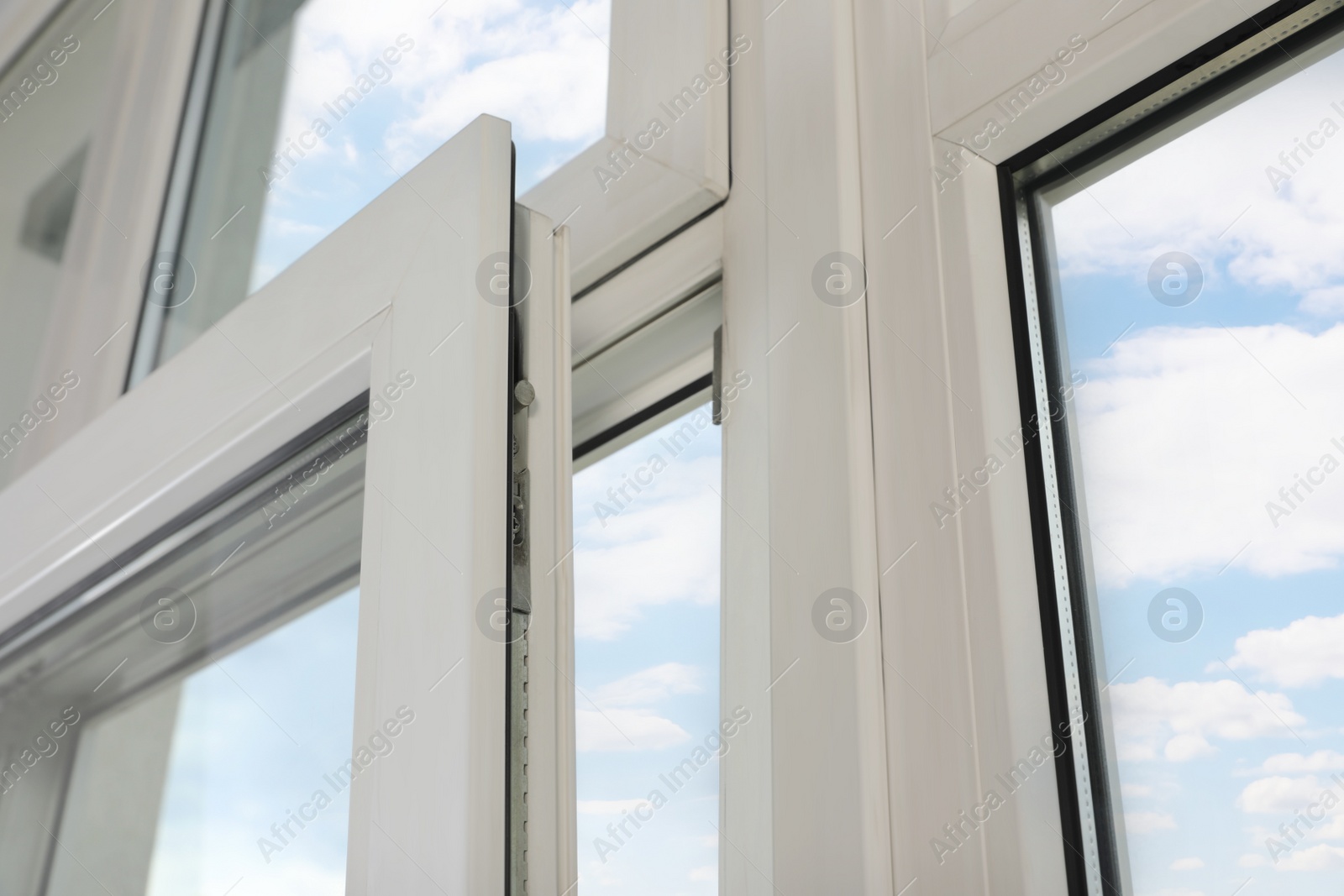 Photo of Open window with white plastic frame indoors, low angle view