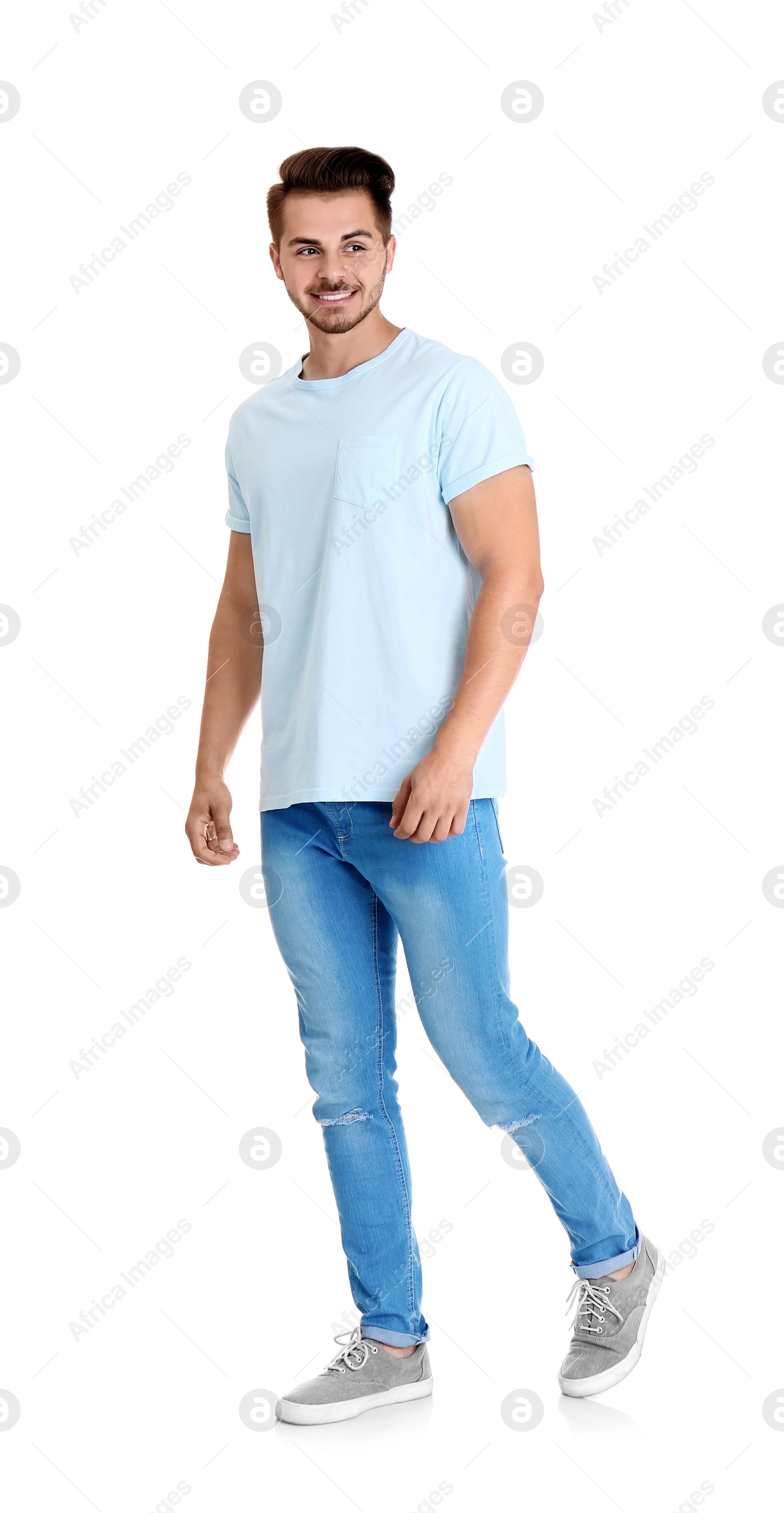 Photo of Young man in stylish jeans on white background