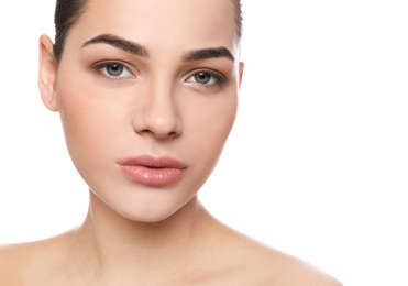 Portrait of young woman with beautiful face and natural makeup on white background, closeup