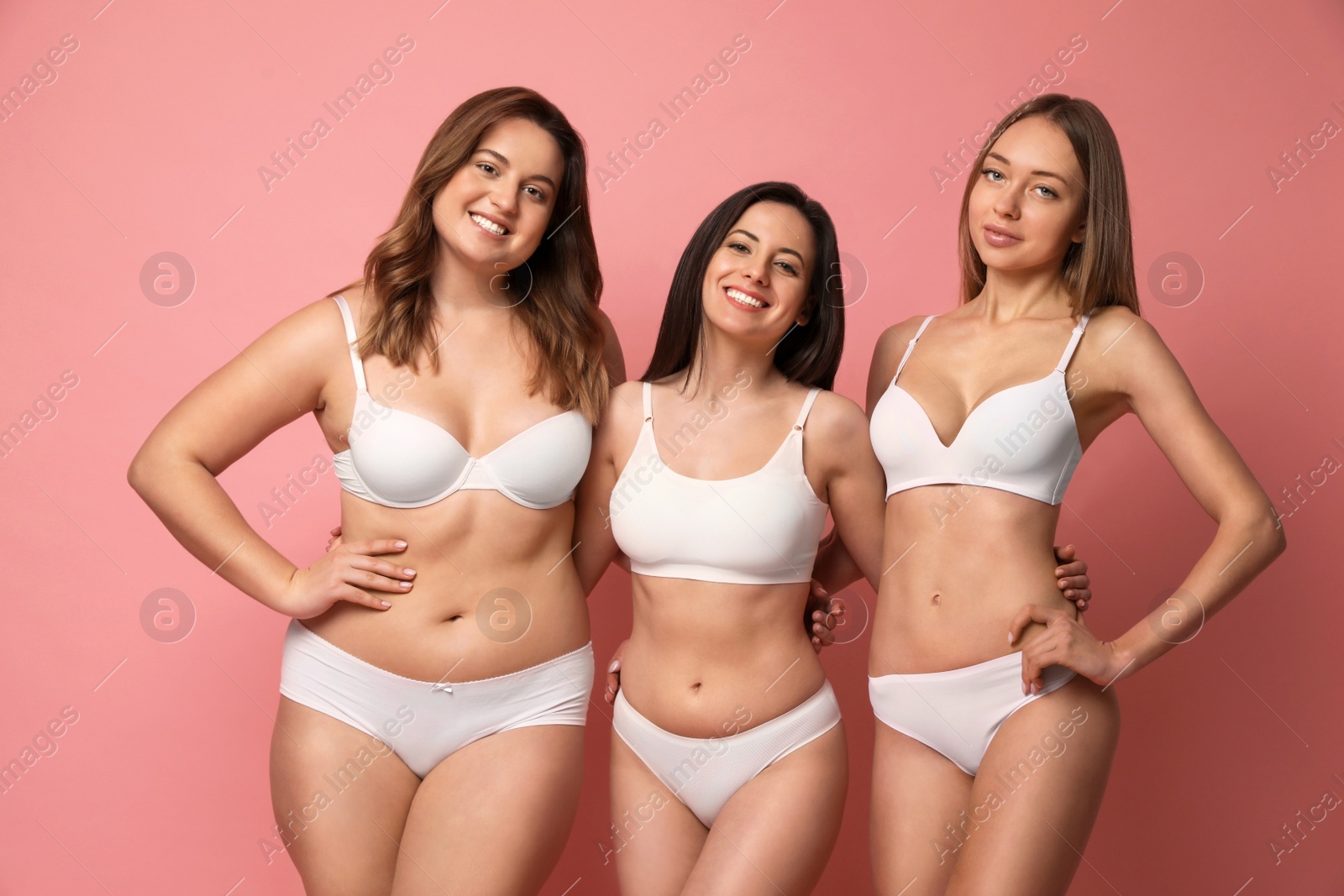 Photo of Group of women with different body types in underwear on pink background