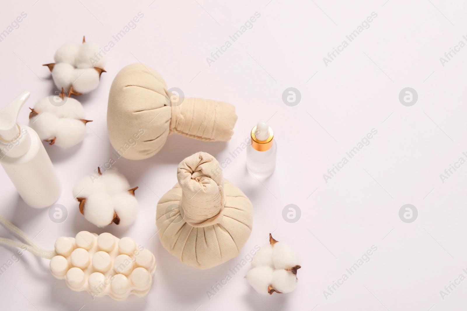 Photo of Bath accessories. Different personal care products and cotton flowers on white background, above view with space for text