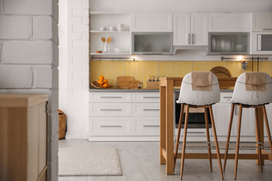 Modern kitchen interior with stylish wooden table