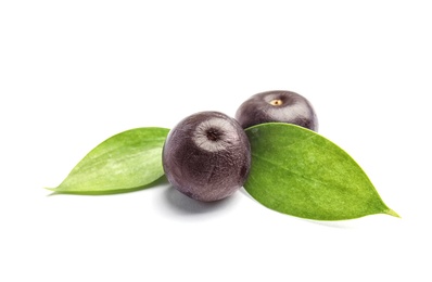 Fresh acai berries with leaves on white background