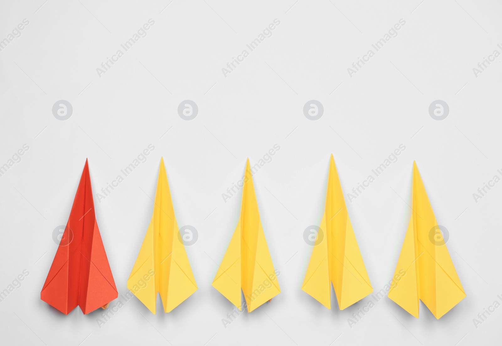 Photo of Handmade colorful paper planes on white table, flat lay. Space for text